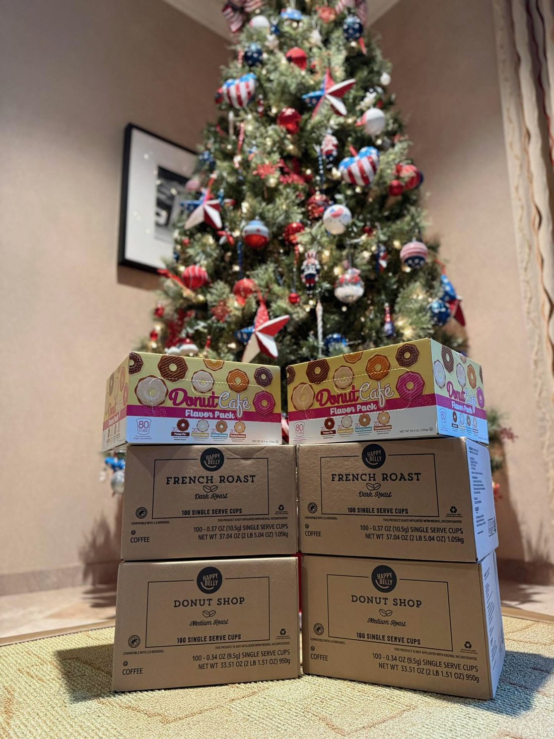Boxes of donated coffee stacked under a decorated Christmas tree