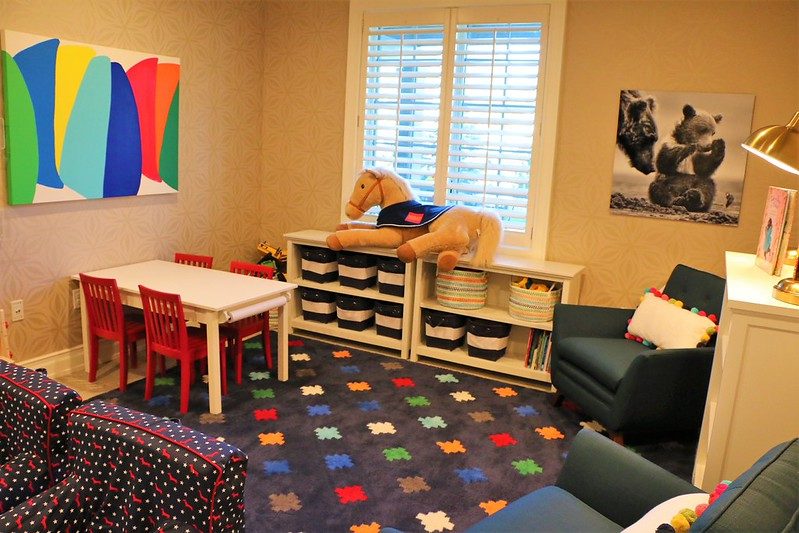 The children's playroom with toys, books, and a craft table