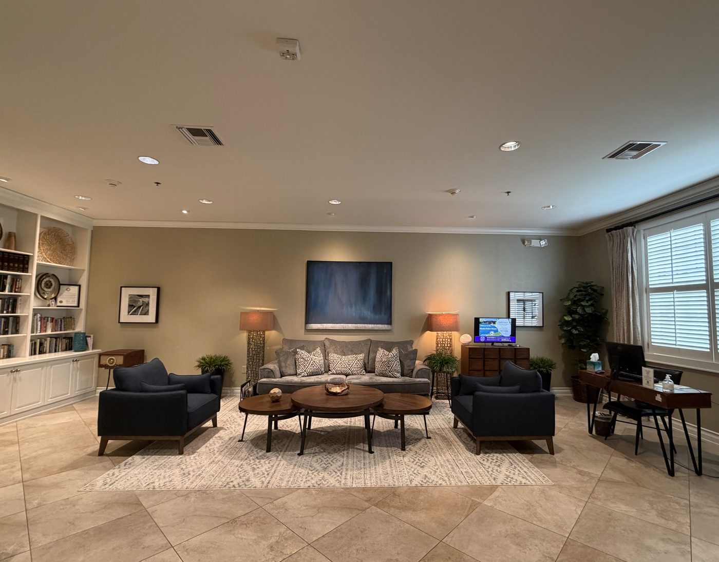 The shared living room with built-in shelves, sofas, and a television