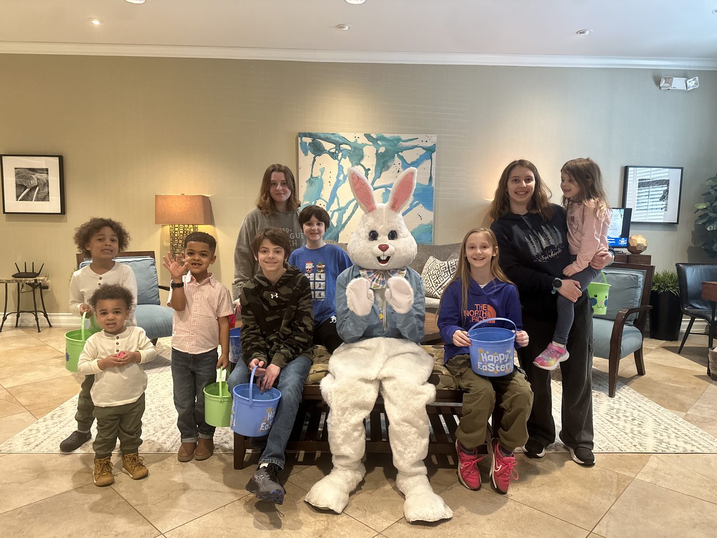 Children and families gathered with the Easter bunny in the Fisher House common room