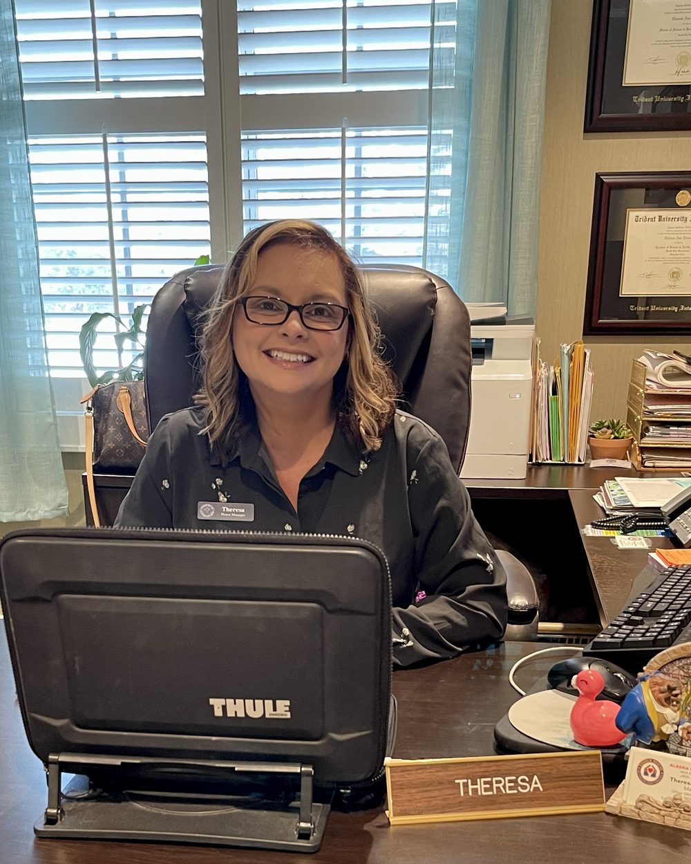 Theresa Nedrow, Alaska Fisher House manager, at her desk in the house office
