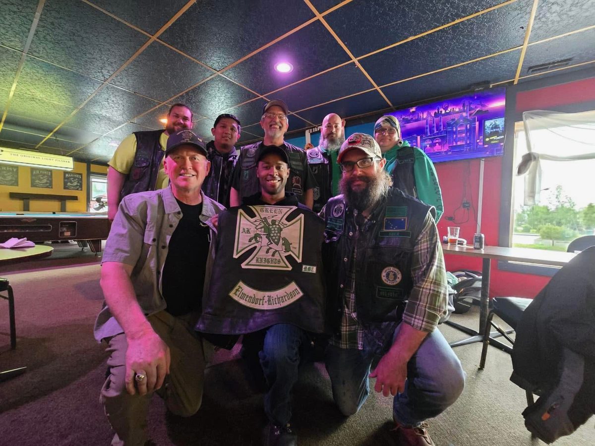 Members of the Green Knights motorcycle club gathered after a fundraiser